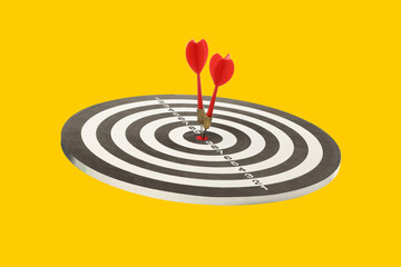 Two red darts hit the target's center