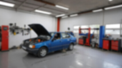 blurry image of the interior of a modern car repair shop, there is a car being repaired, without any people, blurry wallpaper.