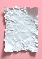 Crumpled white paper on a pink surface