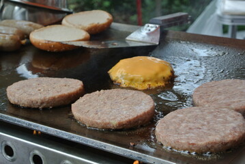 Chef making cheeseburgers on a griddle