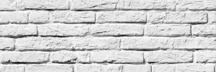 Fototapeta premium Close-up view of a whitewashed brick wall. Horizontal rows of rectangular bricks form a seamless texture. The bricks appear slightly textured, showing subtle variations in shade and surface detail