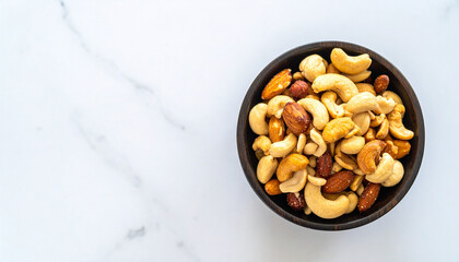 Nut Delight: A delightful assortment of roasted nuts fills a rustic bowl, resting on a pristine surface. Perfect for culinary creations or promoting wholesome snacks.