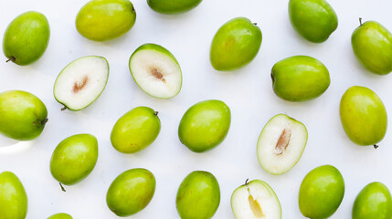 Green jujube fruits on white background.