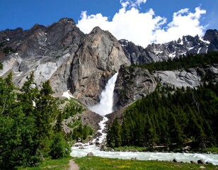 Majestic waterfall cascading down rocky mountains