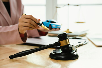 A gavel rests beside legal documents, symbolizing law, justice, court decisions, contracts,...