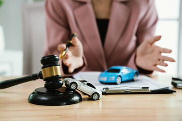 A gavel rests beside legal documents, symbolizing law, justice, court decisions, contracts, insurance claims, accidents, finance, civil cases, authority, agreements, and property-related legal judgmen