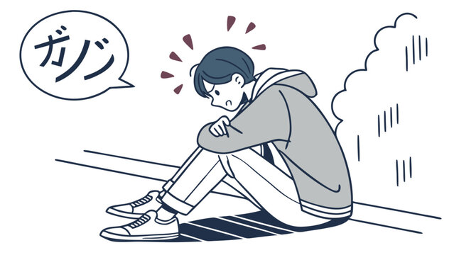 A man sitting on the ground looking stressed.