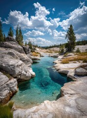 Crystal-clear turquoise water flows through a rocky canyon under a sunny sky