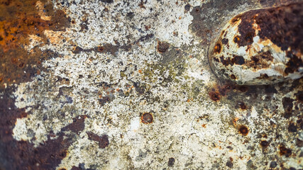 Aged rusty sheet of metal featuring dark corrosion and textured surface imperfections. Patinated iron with rough grunge aesthetic, perfect for old industrial background and abstract design.