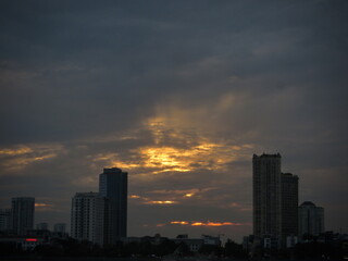 Fototapeta premium Dramatic Sunset Glow Over Downtown Skyline, Low-Light Cityscape on West Lake in Hanoi, Vietnam