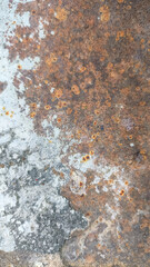 Aged vertical corrugated iron sheet with peeling rust and rough texture, showing signs of corrosion, metal weathering, and industrial decay for background, design, or grunge texture use.