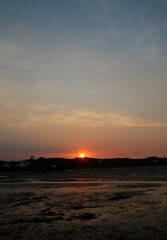 Beautiful sunset with clear sky and calm waves at Utama Raya Beach, Situbondo, Indonesia