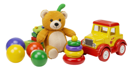 Colorful childrens toys including a teddy bear stacking rings and a toy truck isolated on white background