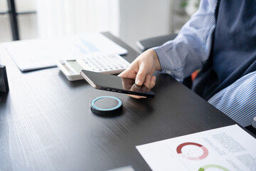 Woman charging smartphone by using magnetic wireless charger