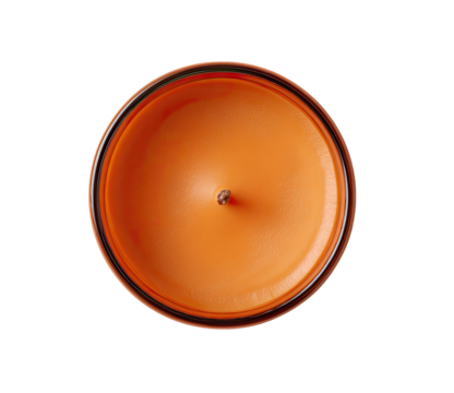 Overhead view of an orange candle.  A round, orange candle with a dark-edged, transparent container.  Small wick visible in the center