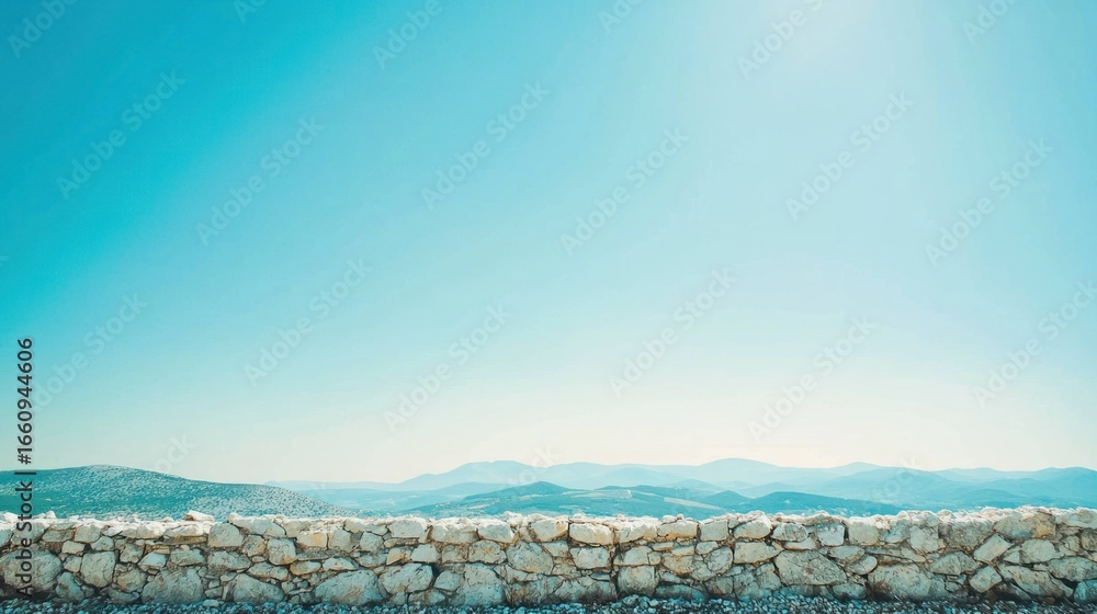 Poster a stone wall runs horizontally across the lower portion of the image, creating a stark contrast with
