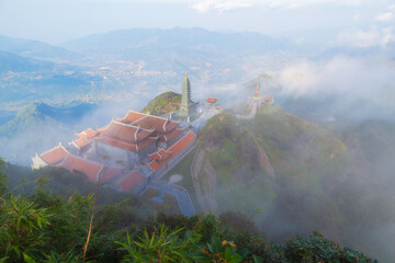 Aerial view from above of white puffy clouds Flying through the clouds above mountain tops.