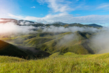 Aerial view from above of white puffy clouds Flying through the clouds above mountain tops.