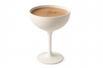 Brandy alexander cocktail featuring grated nutmeg, elegantly served in a white coupe glass against a transparent background