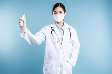 Healthcare worker in mask sprays antiseptic to maintain sanitization and infection control