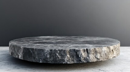 Fototapeta premium Round stone pedestal display on a concrete floor