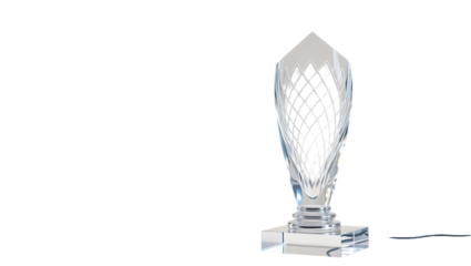 Close up of a clear crystal trophy with a diamond pattern on a black background in a studio shot