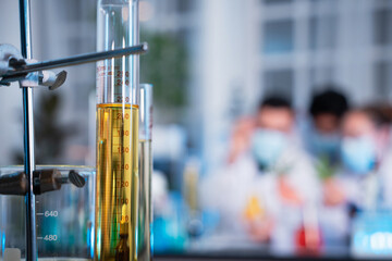 A group of young scientists are conducting experiments in the lab using a microscope., Aspiring scientists are busy running laboratory experiments