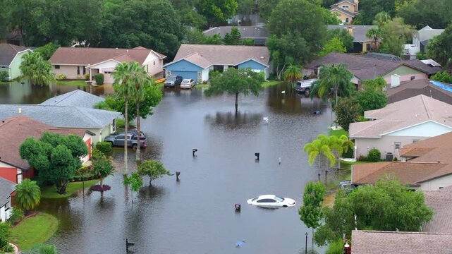 Flooding in Florida caused by tropical storm from hurricane. Suburb houses in residential community surrounded by flood waters in Sarasota. Aftermath of natural disaster.