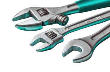 Close-up of assorted adjustable wrenches.  Metal heads and teal handles.  Tools arranged diagonally