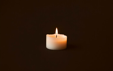 A minimalist photograph of a white candle with a flickering flame, creating a serene atmosphere with a simple composition and elegant contrast.