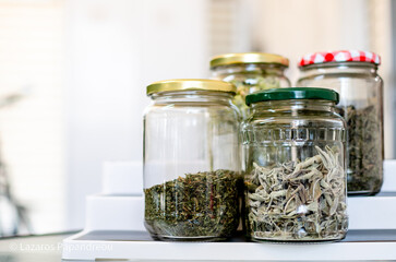 Profile view photo shows spices in a glass jar on a plastic white base. Food concept.