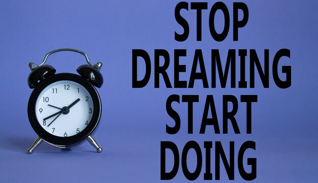 Naklejki Stop Dreaming Start Doing symbol. Beautiful purple background with alarm clock. Business and Stop Dreaming Start Doing concept. Copy space.