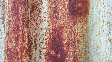 Grunge texture of a weathered zinc fence wall with rust patterns and vintage tones. Perfect for backgrounds, graphic overlays, and decayed metal surface design projects.