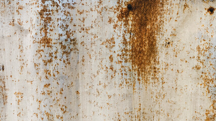 Close-up texture of aged zinc fence with rust details and vintage surface damage. Ideal for design background, industrial themes, and antique weathered material references.