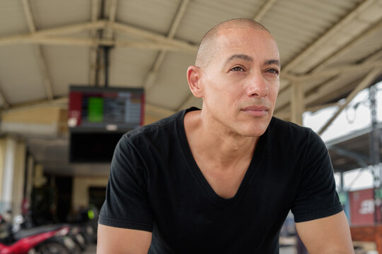 Portrait of Hispanic tourist man at train station platform