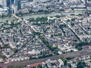 aerial city overview of district "Sachsenhausen" in Frankfurt - Main, Germany, located close to River Main with bridges across the river, railways tracks and parts of downtown in background 