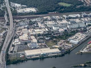 aerial landscape view of Frankfurt Main - Ostend industrial area located next to River Main with highway 661 from North to south and Industrial plants, industrial halls and office buildings