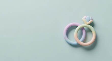 Fototapeta premium Two pastel wedding rings with a diamond gemstone on a light blue background
