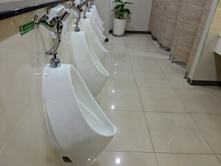 Modern and Clean Male Restroom with White Urinals and Tiles