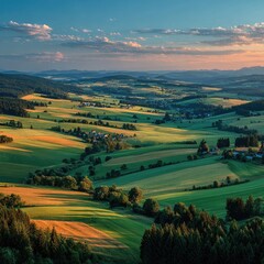Naklejka premium Panoramic view of rolling hills and fields at sunset