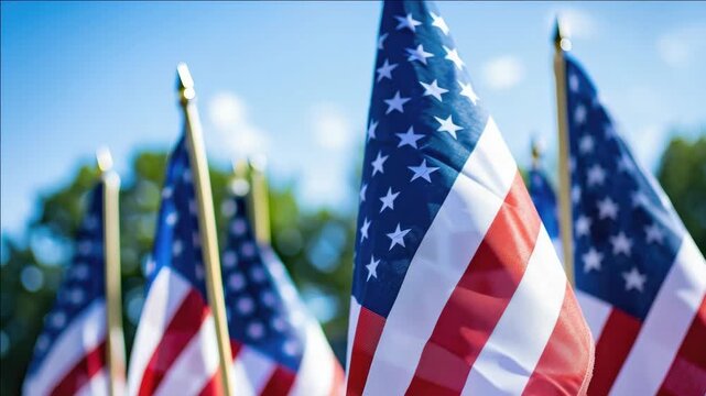 A vibrant display of American flags waving in the wind on a clear day.
