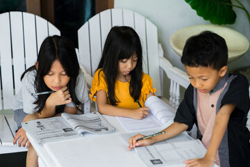 Children sitting around table, having discussion at home