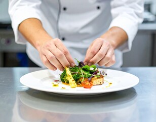 Close-up of chef plating gourmet dish in kitchen