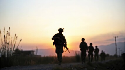 Fototapeta premium Silhouette of armed forces at sunset — representing courage and readiness