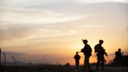 Silhouette of armed forces at sunset &mdash; representing courage and readiness