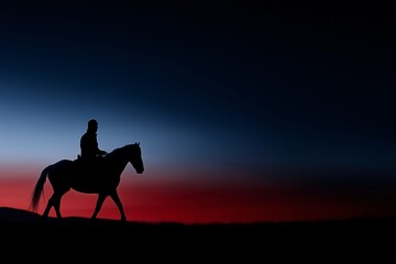 Silhouette of man on horse at sunset, western or cowboy theme