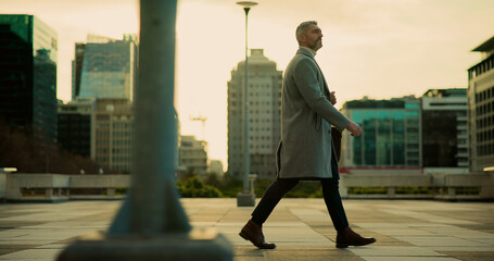 Walking, employee and mature man in city, urban planner and journey to work, commuting or...