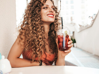 Young beautiful smiling hipster woman with afro curls hairstyle. Female in summer trendy clothes...