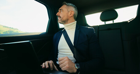 Vision, window and business man in taxi for transportation, conference trip or reflection. Private chauffeur service, commute and thinking with mature person in car for idea, professional or travel © peopleimages.com