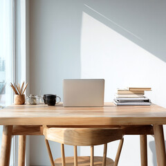 A wooden desk with a laptop, a cup, and a book